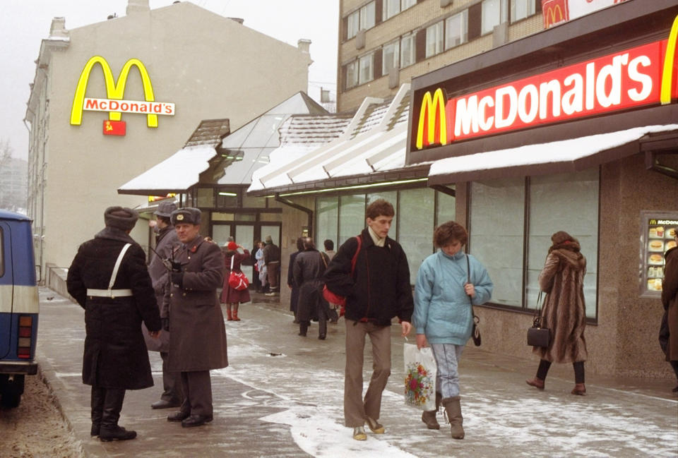 FILE - People walk past Moscow's first McDonalds a day before its opening, in Moscow's Pushkin Square, Jan. 30, 1990. Two months after the Berlin Wall fell, McDonald’s opened its doors in the middle of Moscow. It was the first American fast-food restaurant to enter the Soviet Union. But now, McDonald's is temporarily closing its 850 restaurants in Russia in response to the Ukraine invasion. (AP Photo/Vicktor Yurchenko, File)