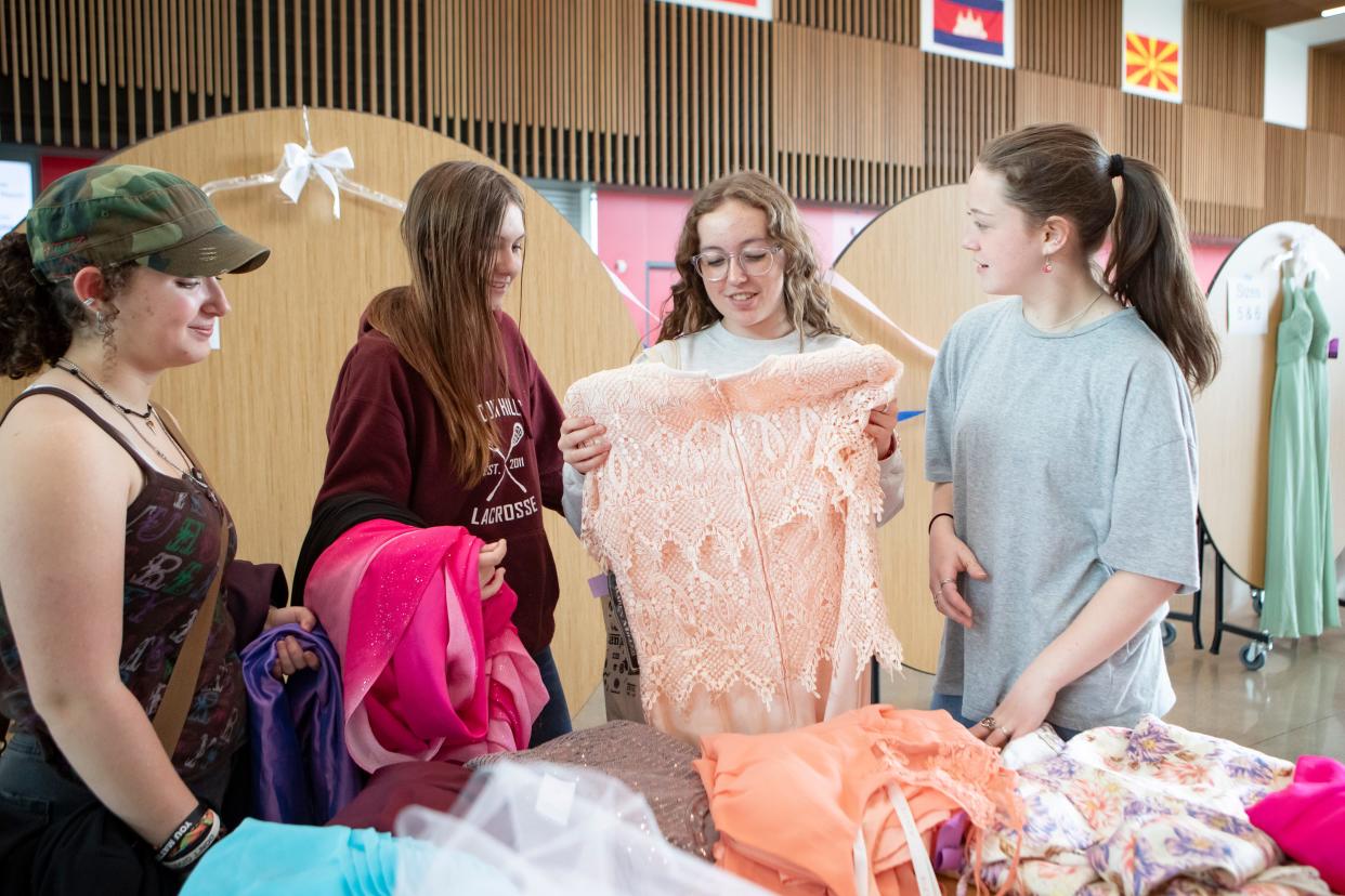 Students look through prom dresses Friday during a giveaway at North Eugene High School.