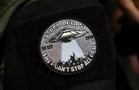 An attendee wears a patch outside a gate to Area 51 as an influx of tourists responding to a call to 'storm' Area 51, a secretive U.S. military base believed by UFO enthusiasts to hold government secrets about extra-terrestrials, is expected in Rachel, Nev