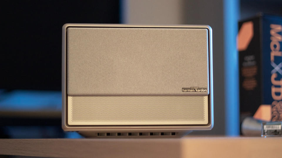 the front of a projector with a speaker grill and a harman kardon logo