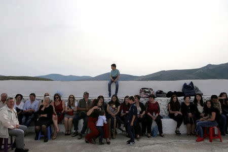 Friends and relatives attend the baptism of the first baby born on the islet of Thymaina after six years, with the financial support of the Aegean Team doctors, on the islet of Ayios Minas, Greece, May 12, 2017. REUTERS/Alkis Konstantinidis