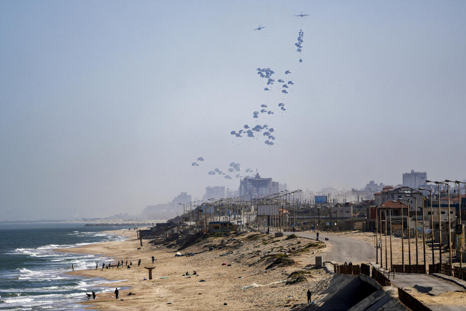 An aircraft airdrops humanitarian aid over the northern Gaza Strip, as seen from central Gaza, Monday, April 1, 2024. (AP Photo/Abdel Kareem Hana)