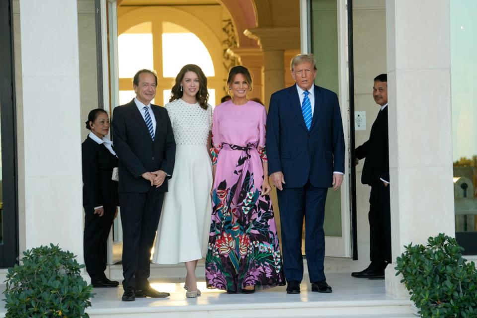 From left, John Paulson, Alina de Almeida, Melania Trump, and Donald Trump gather for a fundraiser at Paulson’s Palm Beach home on 6 April, 2024 (AP)