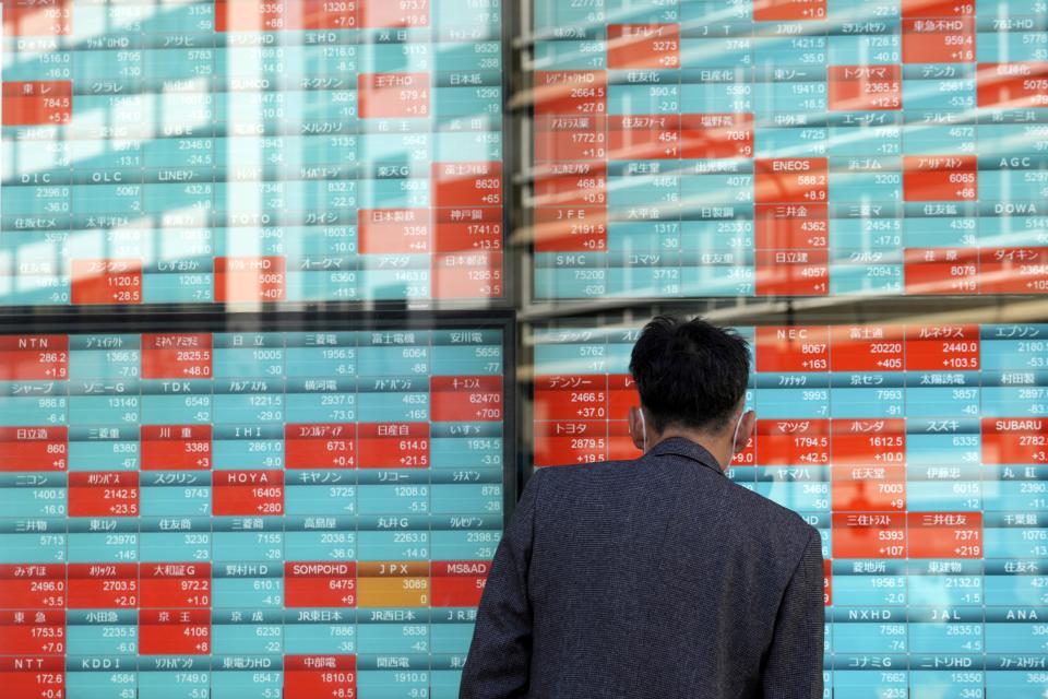 FILE - A person watches an electronic stock board showing Japan's Nikkei 225 index at a securities firm in Tokyo, on Nov. 16, 2023. Shares were mixed in Asia on Friday, Nov. 23, with Hong Kong retreating on selling of property shares following recent gains.(AP Photo/Eugene Hoshiko, File)