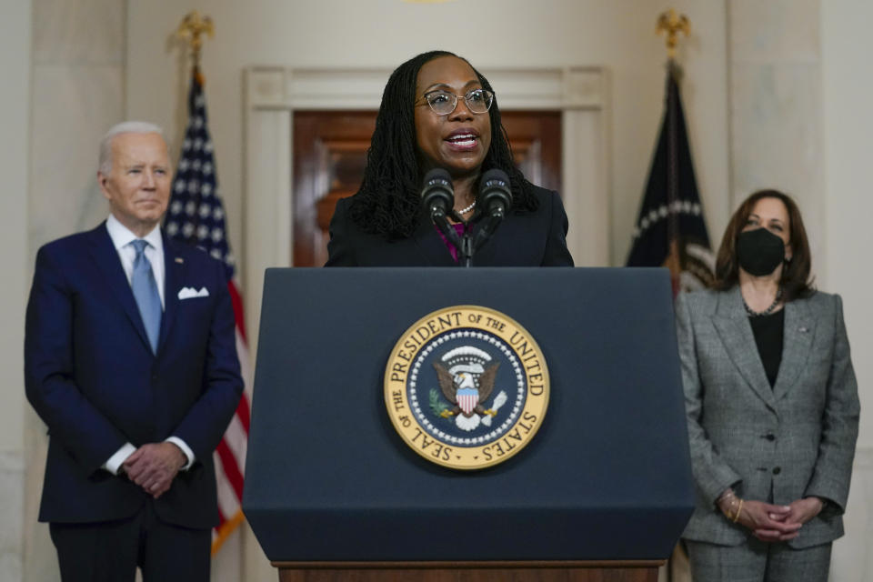 Judge Ketanji Brown Jackson, with President Biden and Vice President Kamala Harris looking on.