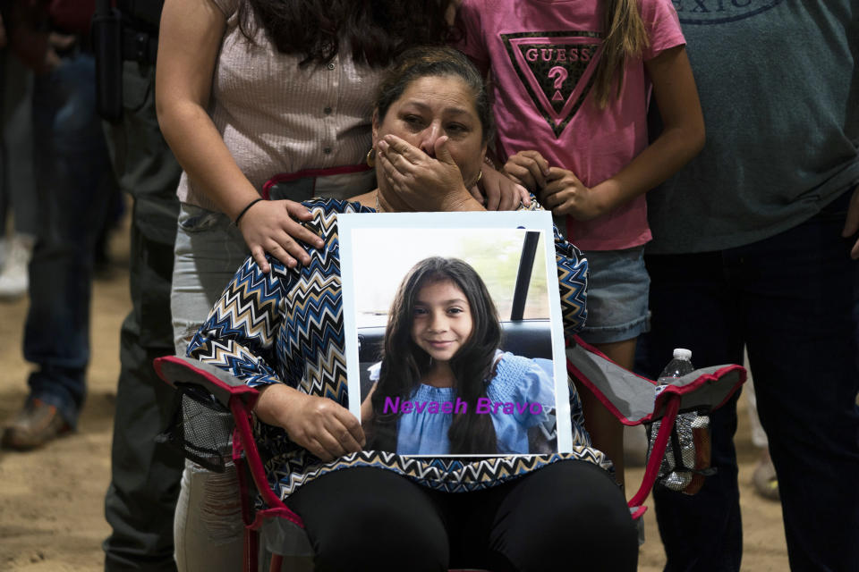 Esmeralda Bravo, 63, sheds tears while holding a photo of her granddaughter, Nevaeh, one of the Robb Elementary School shooting victims, during a prayer vigil in Uvalde, Texas, Wednesday, May 25, 2022. (AP Photo/Jae C. Hong)