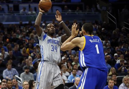 Jan 22, 2017; Orlando, FL, USA; Orlando Magic forward Jeff Green (34) shoots over Golden State Warriors center JaVale McGee (1) during the second half at Amway Center. Golden State Warriors defeated the Orlando Magic 118-98. Mandatory Credit: Kim Klement-USA TODAY Sports