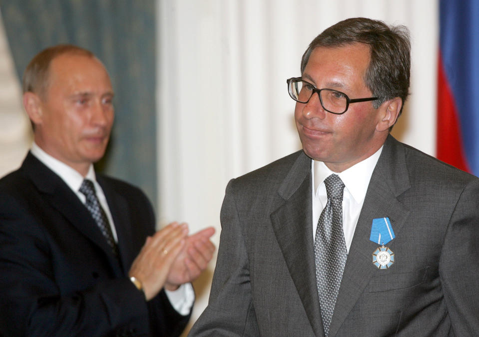 FILE - Russian President Vladimir Putin applauds then Alfa Bank head Petr Aven after awarding him with the Order of Merit to the Fatherland during a ceremony at the Kremlin in Moscow, July 25, 2005. The U.S. Treasury Department on Friday, Aug. 11, 2023, imposed financial sanctions against four Russians on the board of Alfa Group, one of the country’s largest conglomerates with interests in oil, natural gas and banking. Sanctioned by Treasury are Petr Olegovich Aven, Mikhail Maratovich Fridman, German Borisovich Khan and Alexey Viktorovich Kuzmichev. (AP Photo/Alexander Nenenov, Pool, File)