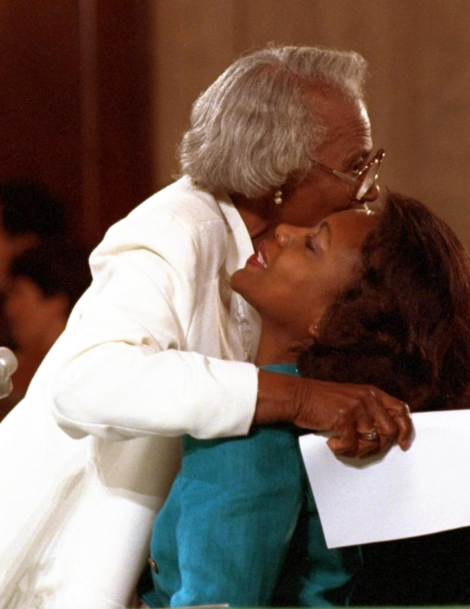 FILE - This Oct. 11, 1991 file photo shows University of Oklahoma law professor Anita Hill receiving a hug from her mother, Erma, after making opening comments to the Senate Judiciary Committee on Capitol Hill in Washington. Hill made national headlines in 1991 when she testified that then-Supreme Court nominee Clarence Thomas had sexually harassed her. Now, more than 20 years later, director Freida Mock explores Hill's landmark testimony and the resulting social and political changes in the documentary "Anita." (AP Photo/Greg Gibson, File)