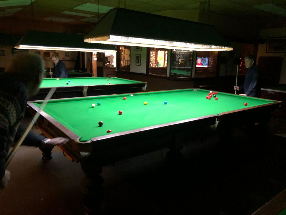 Ian Day, far left, and Syl Goldberg, far right, play a game of snooker at the Romford Snooker Club, outside of London on Feb. 4, 2019.