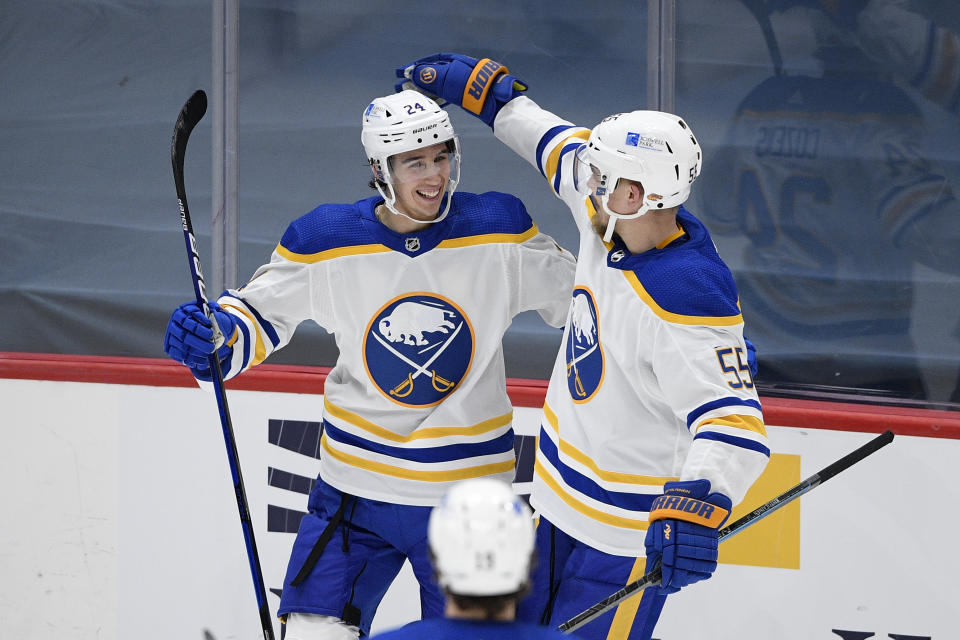 Buffalo Sabres center Dylan Cozens, left, celebrates his goal with defenseman Rasmus Ristolainen (55) during the second period of an NHL hockey game against the Washington Capitals, Friday, Jan. 22, 2021, in Washington. (AP Photo/Nick Wass)