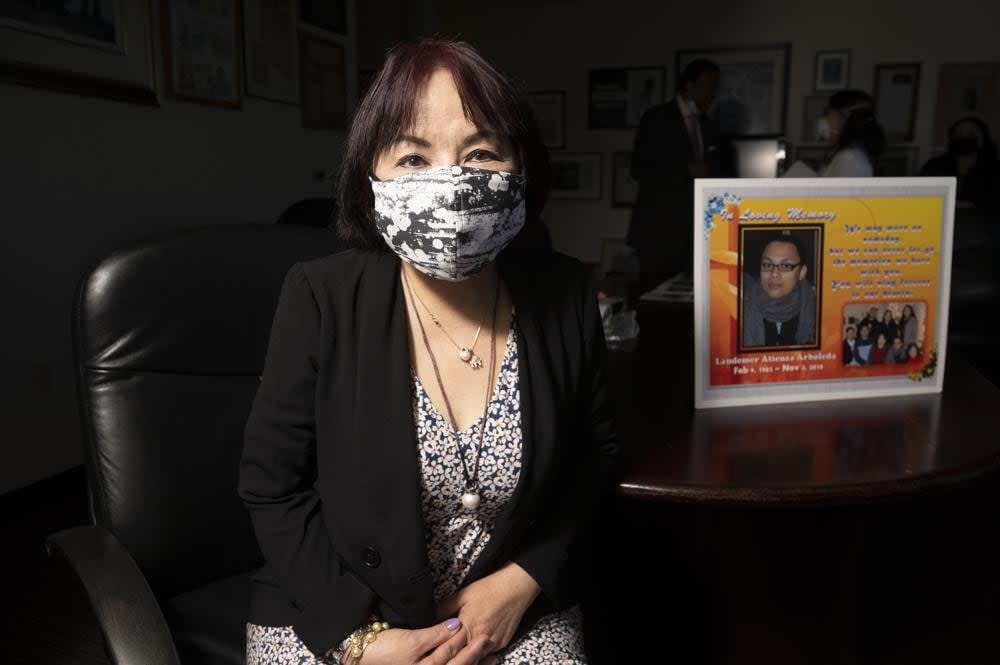 Jeannie Atienza sits with a picture of her son Laudemer Arboleda on Monday, May 3, 2021, in Oakland, Calif. Danville police officer Andrew Hall faces felony charges for shooting and killing Arboleda during a 2018 car chase. (AP Photo/Noah Berger)