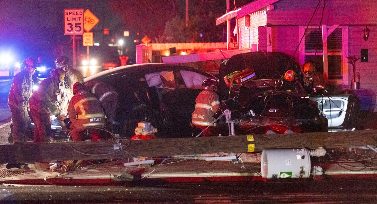 Emergency personnel work Saturday, May 27, 2023 at Murray Avenue and Johnson Street after a collision between two cars into a house and power pole left many residents and businesses in the area without power.