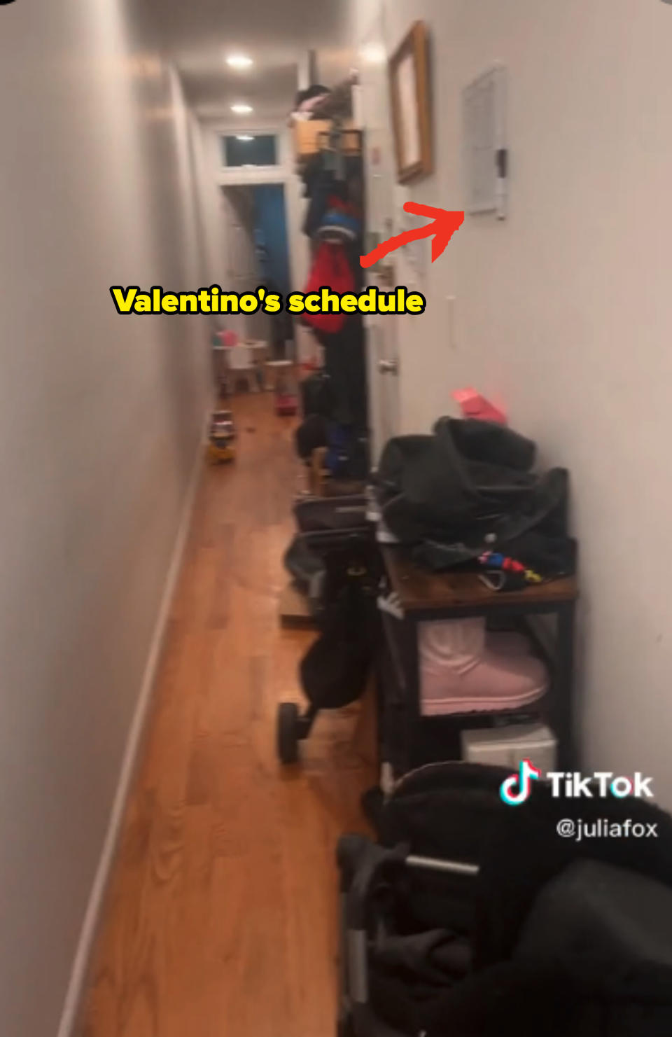 An arrow points at Valentino's schedule on the wall that is lined with a shoe rack and strollers