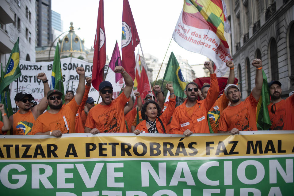 Oil workers march against layoffs at the state oil company Petrobras, in Rio de Janeiro, Brazil, Tuesday, Feb. 18, 2020. Brazilian oil workers and oil giant Petrobras were locked in a power struggle Tuesday over the company's privatization plans, with the union saying thousands of employees are on an indefinite strike. (AP Photo/Silvia Izquierdo)