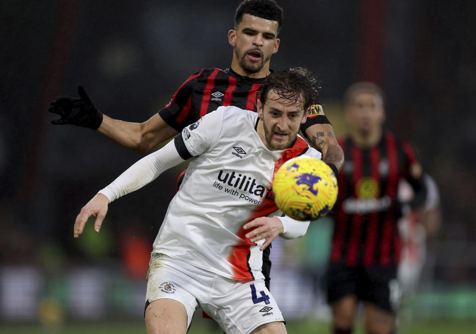 Luton Town's Tom Lockyer, front, and Bournemouth's Dominic Solanke battle for the ball during the English Premier League soccer match between Bournemouth and Luton Town at the Vitality Stadium, Bournemouth, England, Saturday Dec. 16, 2023. (Steven Paston/PA via AP)