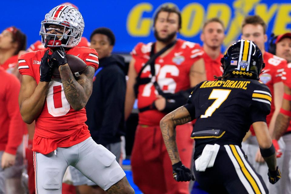 Xavier Johnson #0 of the Ohio State Buckeyes catches a pass against Kris Abrams-Draine #7 of the Missouri Tigers during the third quarter Dec. 29, 2023, in the Goodyear Cotton Bowl at AT&T Stadium in Arlington, Texas.