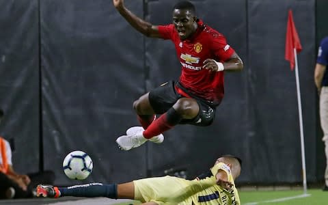 Manchester United defender Eric Bailly has the ball knocked away by Club America defender Luis Reyes - Credit: AP