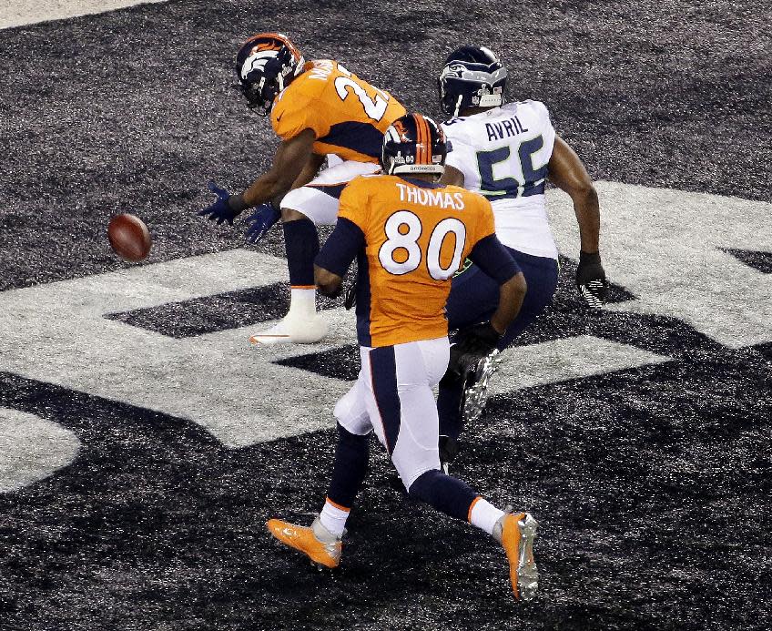 Denver Broncos' Knowshon Moreno (27) recovers the football in the end zone for a safety as Seattle Seahawks' Heath Farwell (55) and teammate Julius Thomas (80) chase him during the first half of the NFL Super Bowl XLVIII football game Sunday, Feb. 2, 2014, in East Rutherford, N.J. (AP Photo/Charlie Riedel)