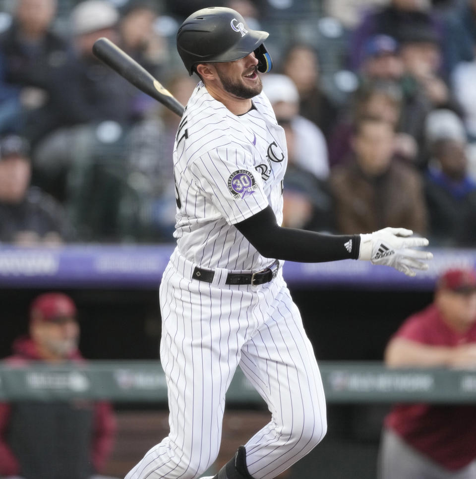 Colorado Rockies' Kris Bryant watches his single off Arizona Diamondbacks starting pitcher Merrill Kelly during the first inning of a baseball game Friday, April 28, 2023, in Denver. (AP Photo/David Zalubowski)