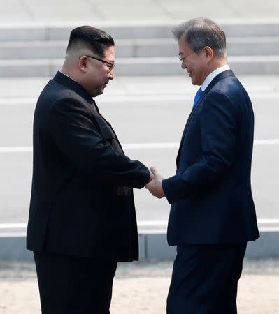 South Korean President Moon Jae-in and North Korean leader Kim Jong Un meet in the truce village of Panmunjom inside the demilitarized zone separating the two Koreas, South Korea, April 27, 2018. Korea Summit Press Pool/Pool via Reuters