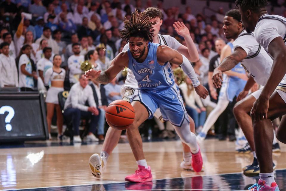 North Carolina guard RJ Davis (4) reaches for a ball against Georgia Tech during their game at McCamish Pavilion.