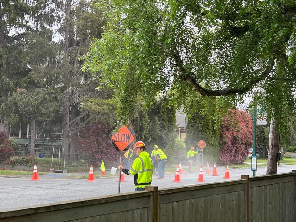 A Bellingham Public Works crew removes crosswalk markings made by neighbors on Eldridge Avenue in Bellingham on May 9.