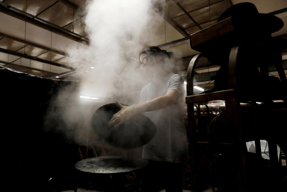 Steam is used to mould a fur hat in Borsalino's hat factory, in Spinetta Marengo, near Alessandria, Italy, Thursday, Jan. 17, 2019. Borsalino's prized felt hats are handmade by 80 workers in its Piemonte factory, many who have worked there for decades, with original machinery that use hot water and steam to transform rabbit fur into highly prized felt, that is formed into clochards, dyed and molded by hand to create the latest styles. (AP Photo/Antonio Calanni)