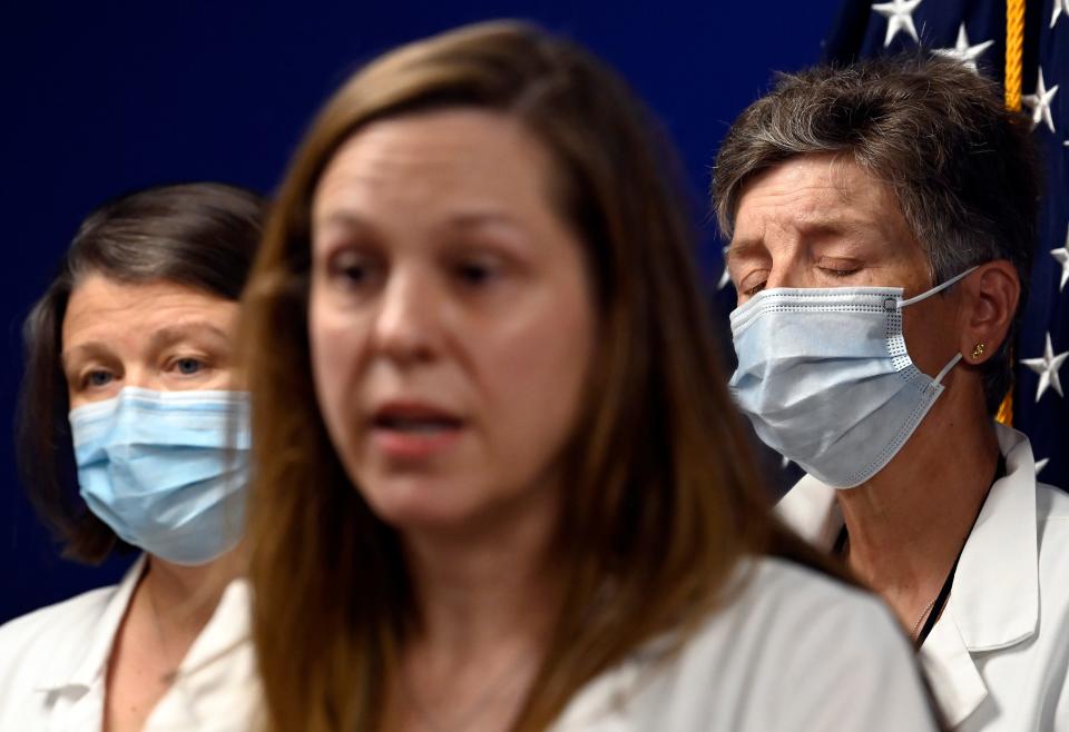 Emergency Medicine Physician, Mary Jane Brown, right, listens to doctor Dana Cardin speak during a press conference after the United States Supreme Court overturned Roe v. Wade, ending constitutional right to abortion on Friday, June 24, 2022, in Nashville, Tenn.