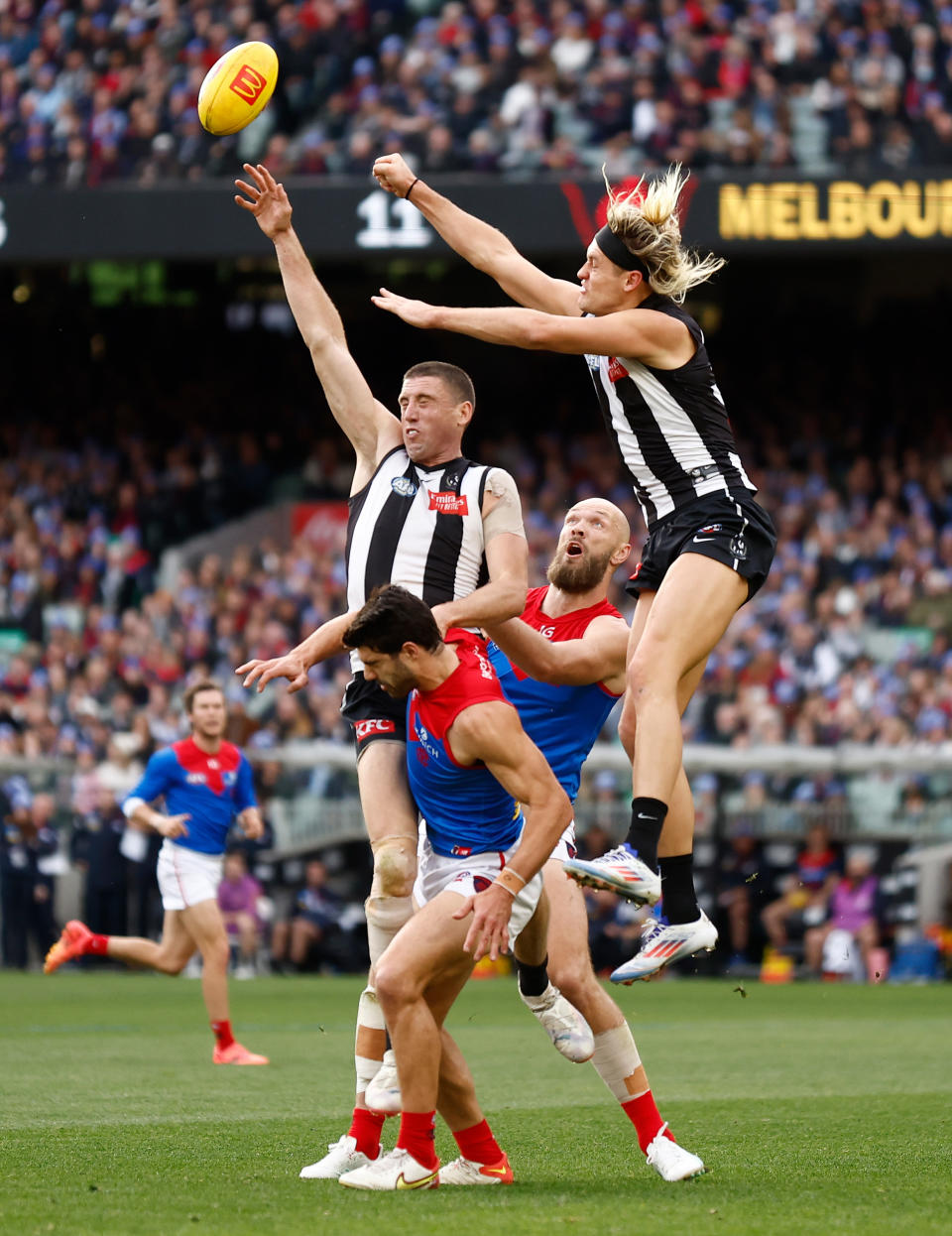 MELBOURNE, AUSTRALIA - JUNE 10: Darcy Cameron of the Magpies and Christian Petracca of the Demons collide during the 2024 AFL Round 13 match between the Collingwood Magpies and the Melbourne Demons at The Melbourne Cricket Ground on June 10, 2024 in Melbourne, Australia. (Photo by Michael Willson/AFL Photos via Getty Images)