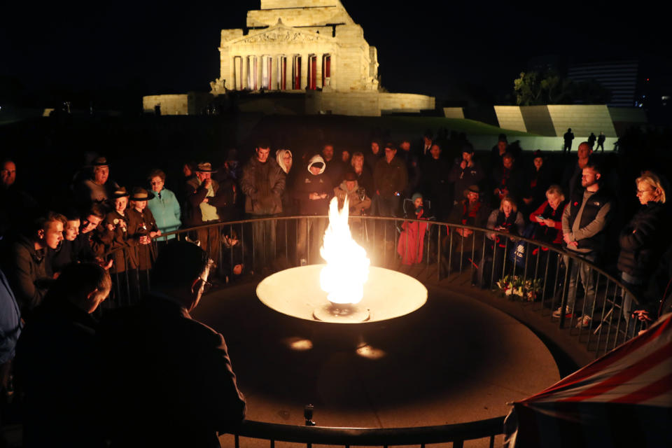 Crowds gather during the Anzac Day dawn service in front of the perpetual flame at the Shrine of Remembrance in Melbourne. Source: AAP