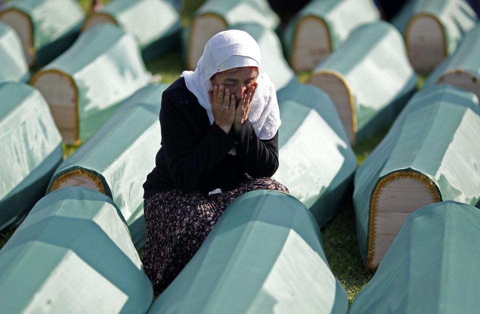A Bosnian Muslim woman cries near the coffin of a relative before a mass funeral for bodies found in a mass grave, in Kozarac, near Prijedor, July 19, 2014.(EUTERS/Dado Ruvic)