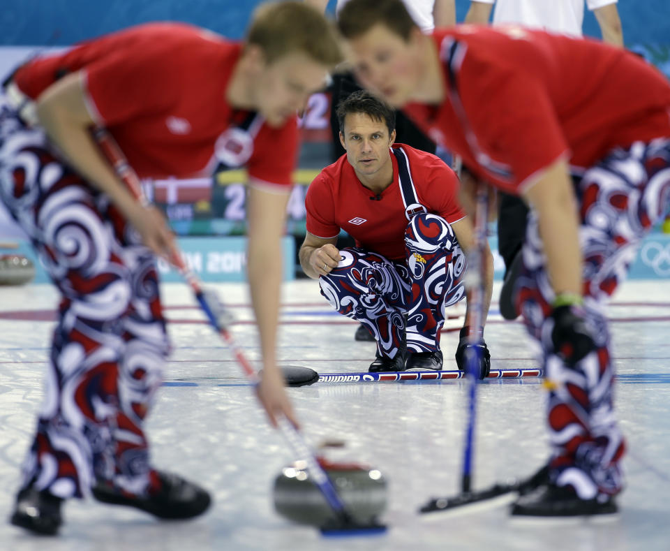 Norway's Thomas Ulsrud delivers the rock to his sweepers during a round robin match against Denmark at the 2014 Winter Olympics, Monday, Feb. 17, 2014, in Sochi, Russia. (AP Photo/Morry Gash)