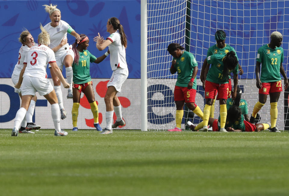 England's Steph Houghton, third from left, celebrates with teammates after scoring her side's first goal during the Women's World Cup round of 16 soccer match between England and Cameroon at the Stade du Hainaut stadium in Valenciennes, France, Sunday, June 23, 2019. (AP Photo/Michel Spingler)