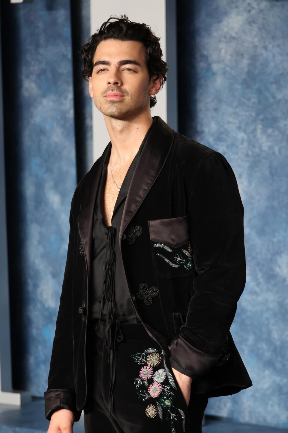 Joe Jonas in velvet suit with floral embroidery on the red carpet