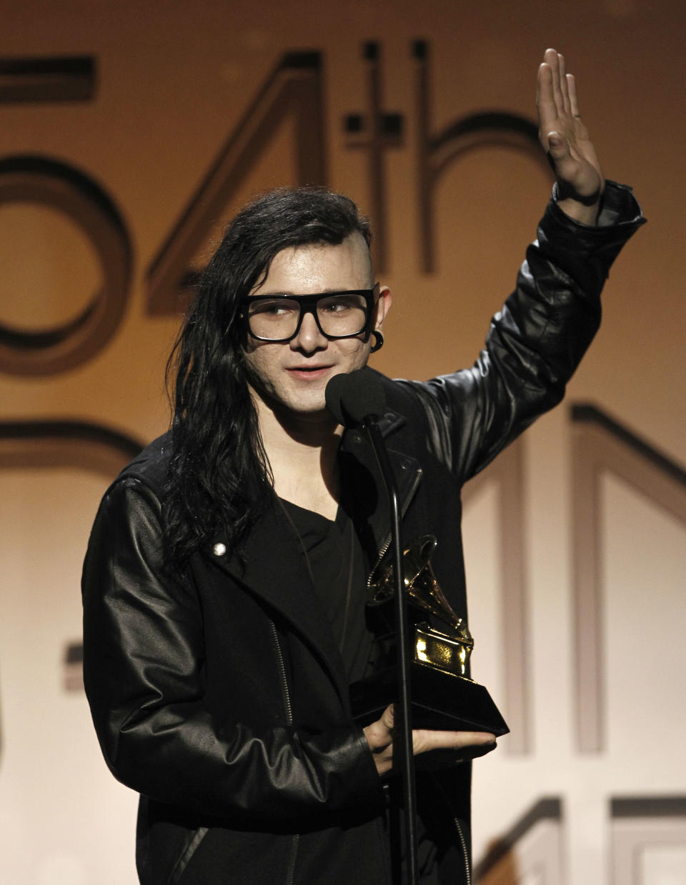 FILE - In this Feb. 12, 2012, file photo, Skrillex accepts the award for best remixed recording non-classical, for Cinema, at the 54th annual GRAMMY Awards pre-show in Los Angeles. Skrillex, whose sound is a mix of electronic, grunge and dubstep, was a fairly unknown Los Angeles DJ-producer before winning three Grammy Awards this year. (AP Photo/Matt Sayles, file)