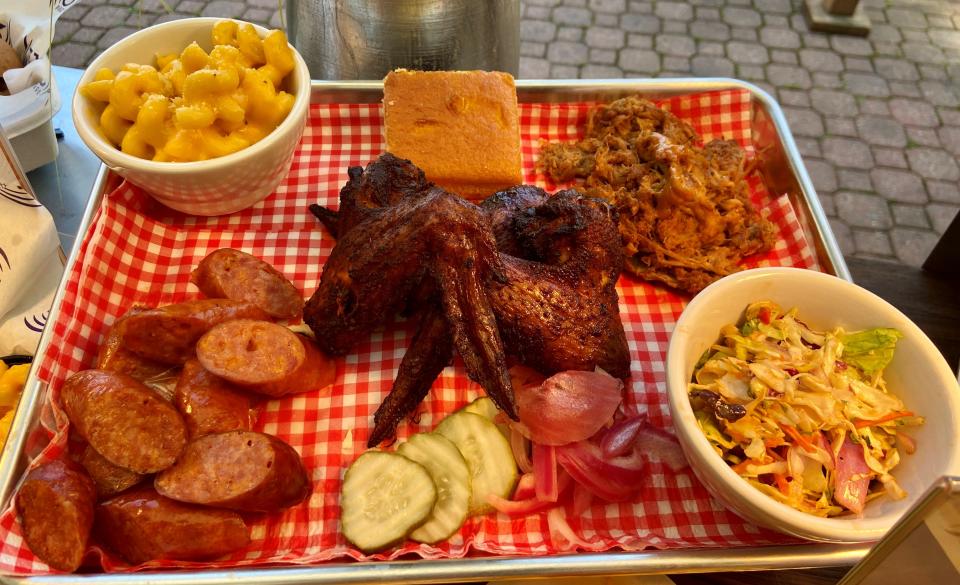 The smokehouse platter is a new offering at Pine Knob Music theatre  with smoked chicken wings, sausage, smoked pork barbecue, mac and cheese, cole slaw and cornbread.