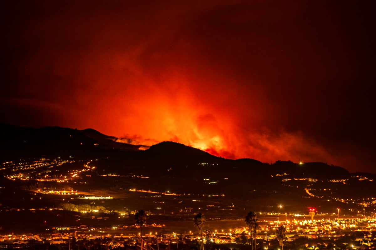 Flares are seen on the horizon as the fire advances through the forest toward the town of La Laguna and Los Rodeos airport in Tenerife on Saturday (Copyright 2023 The Associated Press. All rights reserved.)