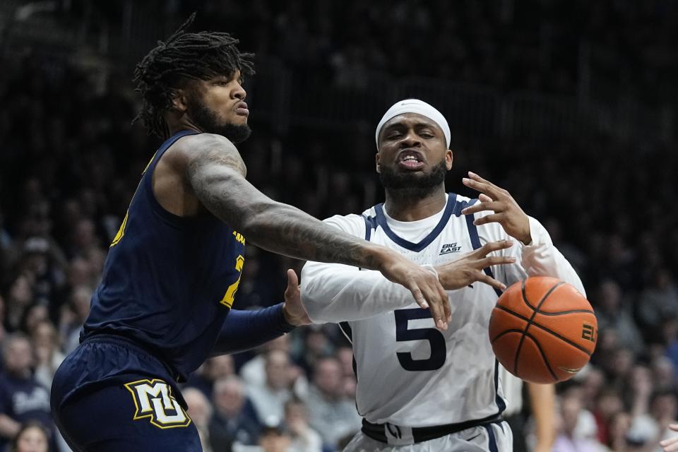 Butler's Posh Alexander (5) has the ball stripped by Marquette's David Joplin during the first half of an NCAA college basketball game, Tuesday, Feb. 13, 2024, in Indianapolis. (AP Photo/Darron Cummings)