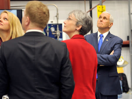 U.S. Vice President Mike Pence looks over the Dragon crew capsule inside the SpaceX hangar at Launch Complex 39-A, where the space ship and Falcon 9 booster rocket are being prepared for a January 2019 launch at Cape Canaveral, Florida, U.S. December 18, 2018. REUTERS/Steve Nesius