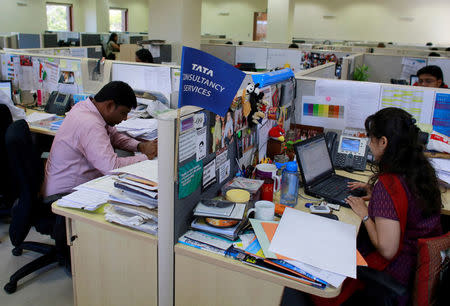 FILE PHOTO: Employees of Tata Consultancy Services (TCS) work inside the company headquarters in Mumbai, India, March 14, 2013. REUTERS/Danish Siddiqui/File Photo