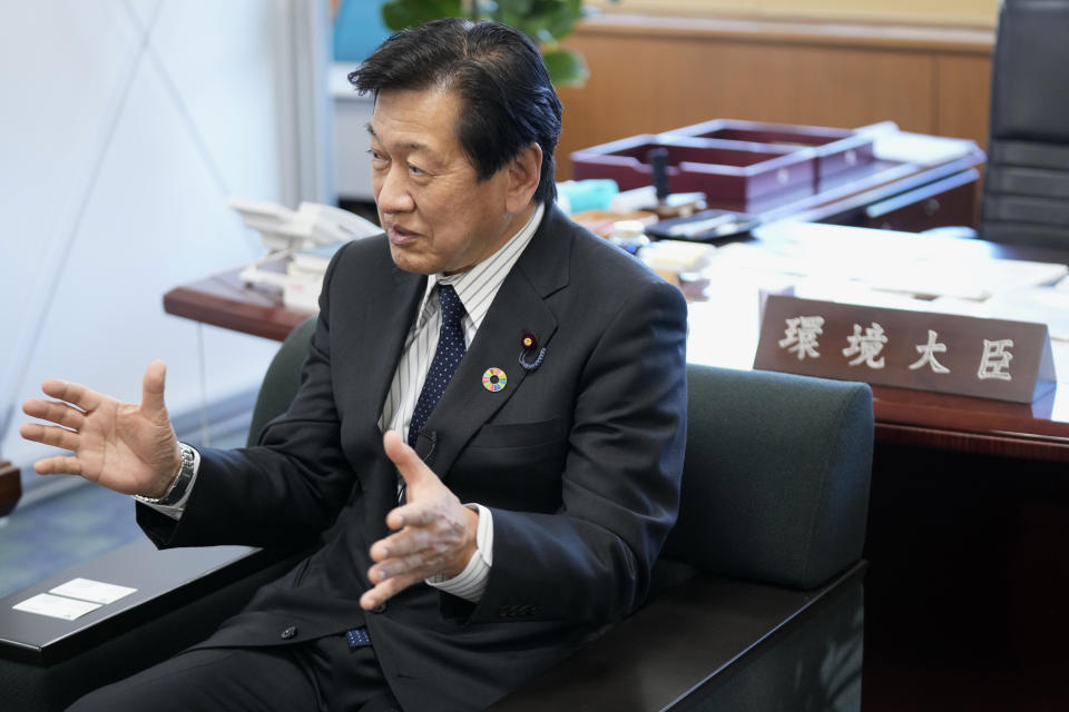 Japanese Environment Minister Tsuyoshi Yamaguchi speaks during an interview with The Associated Press Tuesday, Jan. 18, 2022, in Tokyo. Japan will gradually phase out coal plants over the next two decades while developing new technologies to reduce, capture and utilize carbon, Yamaguchi said Tuesday. (AP Photo/Eugene Hoshiko)