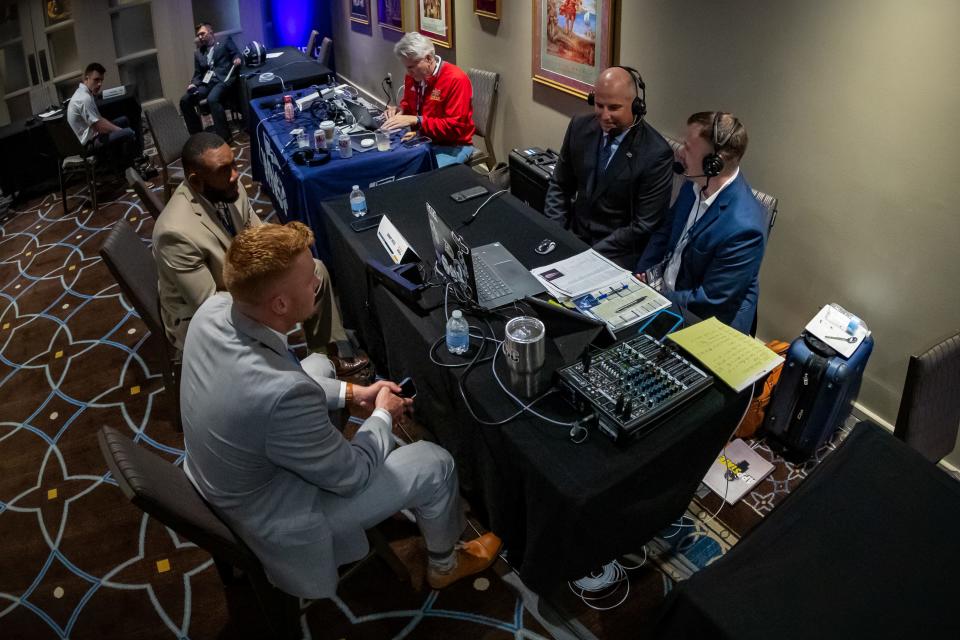 The Georgia Southern contingent, led by head coach Clay Helton, is interviewed by Danny Reed of the Georgia Southern Sports Network on Tuesday at the 2022 Sun Belt Conference Football Media Days at the Sheraton New Orleans Hotel. On the left side of the table, defensive end Dillon Springer and quarterback Kyle Vantrease await their turns to be interviewed.