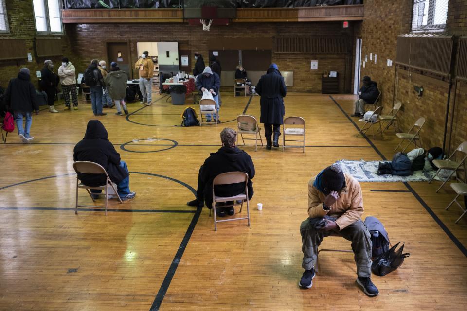 People who are homeless sit inside a warming station at Broad Street United Methodist Church. They were counted Thursday as pat of a "point-in-time" tally of homeless adults, teens and children that the U.S. Department of Housing and Urban Development uses to determine funding.