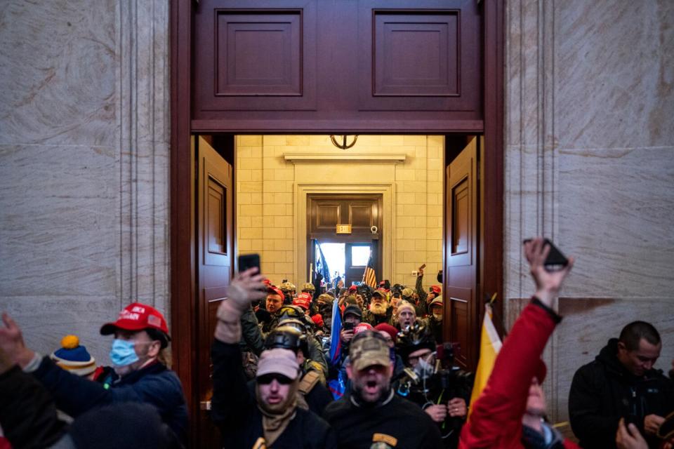 A Pro-Trump insurrectionist mob files into the Rotunda of the U.S. Capitol