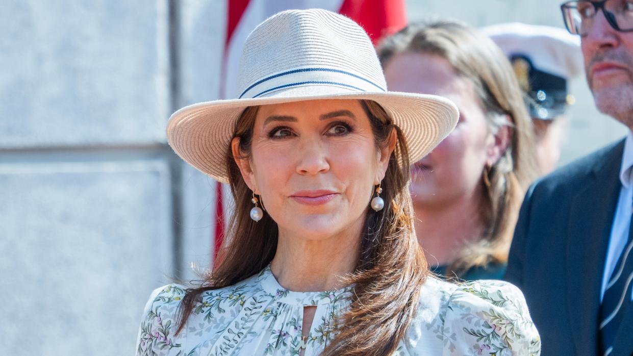  Queen Mary of Denmark, wearing a green floral dress and a sunhat, is welcomed by the public as she arrives in Gråsten. 