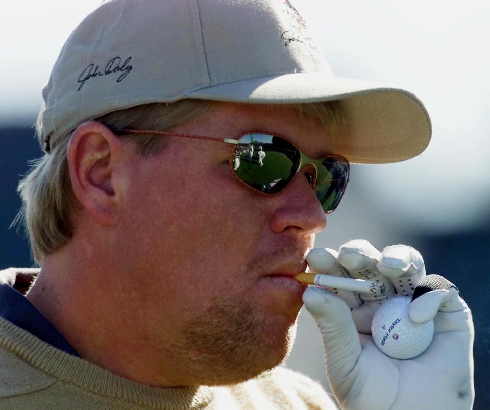 Golfer John Daly of the US smokes a cigarette 05 April, 2000 on the 10th tee before the final practice round for the 2000 Masters Golf Tournament at Augusta National Golf Club in Augusta, GA. The tournament will start on 06 April, 2000. (ELECTRONIC IMAGE) AFP PHOTO/JEFF HAYNES (AFP via Getty Images)