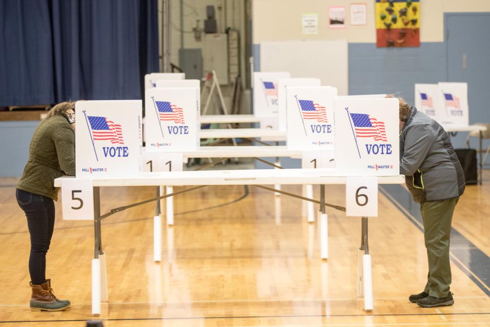 Voters cast their ballots while maintaining social distance in Hermon, Maine.