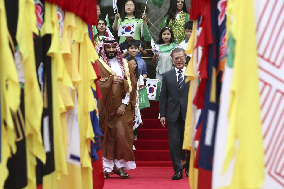 South Korean President Moon Jae-in, right, and Saudi Crown Prince Mohammed bin Salman view an honor guard during a welcoming ceremony at the presidential Blue House, Wednesday, June 26, 2019, in Seoul, South Korea. Bin Salman is visiting South Korea for two days - the first time by an heir to the throne of Saudi Arabia since 1998. (Chung Sung-Jun/Pool Photo via AP)