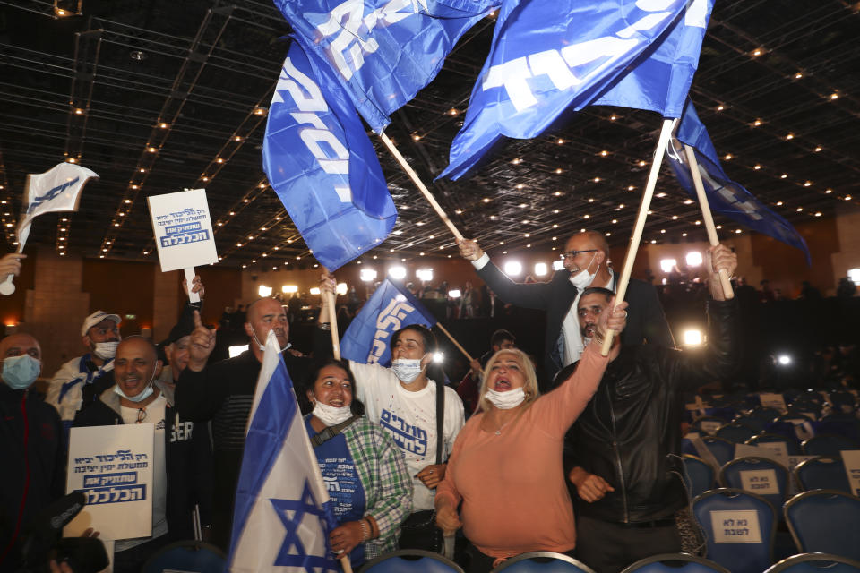 Israeli Prime Minister Benjamin Netanyahu's supporters celebrate after first exit poll results for the Israeli elections at his party's headquarters in Jerusalem, Tuesday, March. 23, 2021. (AP Photo/Ariel Schalit)